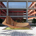 Modern Architectural Courtyard With Red Buildings Sculpture Water Ponds Green Lawn And Paved Ground