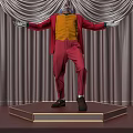 Clown In Pink Coat Yellow Vest With Mask Standing On Stage Red Curtains Arms Outstretched
