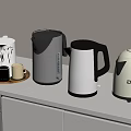 Modern Kitchen Countertop With Stylish Electric Kettles And Mugs On White Cabinets