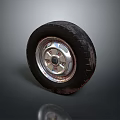 Black Car Tire With Shiny Metal Wheel Rim And Tread Pattern On Dark Background