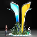 Modern Sculptural Installation With Yellow Body Blue Glowing Sides And Green Plants Around