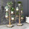 Multi Tiered Golden Plant Stands With Various Green Potted Plants Against Gray Wall
