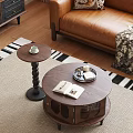 Round Wooden Coffee Table With Open Book Tray And Small Side Table By Leather Sofa