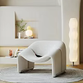 Modern Leisure Chair With Curved Design Soft Fabric White Floor Lamp And Green Plants