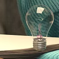 Transparent Light Bulb Placed On Open Book With Teal Knitted Background And Soft Texture 3d model