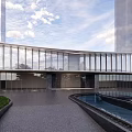 Modern Sales Office Building With Curved Glass Curtain Wall And Landscaped Water Feature