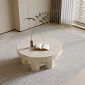 Round Stone Coffee Table With Cylindrical Legs Open Book Green Plant On Light Rug