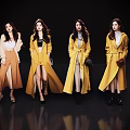 Women in Stylish Yellow Beige Brown Coats Standing Against Black Background With Reflections