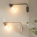 Modern Black and Gold Wall Lamps with Exposed Bulbs Curved Arms Near Green Plant