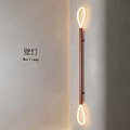 Modern Wall Lamp with Double Ring Lights and Sleek Copper Frame on Beige Wall