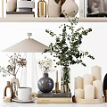 Elegant Ornamental Decor Arrangement With Green Plants Vases Candles Books And Decorative Sculptures