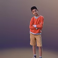Young Boy In Orange Sweater With White Cuffs And Khaki Shorts Standing With Arms Crossed