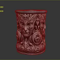 Ornate Metallic Cylindrical Container With Intricate Face Carvings And Decorative Patterns