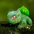 Green Reptile With Red Eyes And Green Back Structure On Grassy Ground