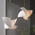Modern White Pleated Fan Shaped Chandeliers With Gold Accents Against Gray Wall And Green Plants