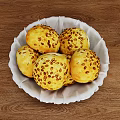 Freshly Baked Golden Yellow Bread Buns With Sesame Seeds in White Plate on Wooden Tabletop