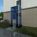 Modern Building Exterior Design With Transparent Glass Elevator And Grass Shrubs
