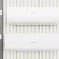 MI and GREE Air Conditioner Fan Units Mounted on Striped Wall with Power Sockets