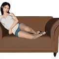 Young Woman Lying On Beige Leather Sofa With White Tank Top Blue Shorts Black Shoes