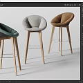 Three Modern Minimalist Bar Stools With Green Gray Brown Upholstered Seats And Wooden Legs