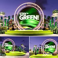 Green Themed Stage With Stay Green Sign And Plant Decorations At Night
