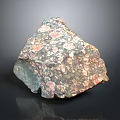 Natural Wood Stone Sample with Colorful Speckled Texture and Irregular Shape