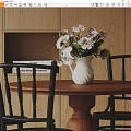Wooden Desk With White Vase Light Pink Flowers Black Chairs And Books On Cabinet