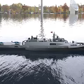 Modern Warship Floating on Water With Glass Buildings and Trees Background Displaying Number 888