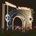 Ornate Decorative Archway With Illuminated Wings Golden Patterns And Surrounding Purple Blue Red Flowers