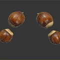 Four Shiny Brown Chestnuts Floating On Black Background With Reflections