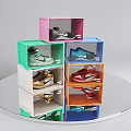 Colorful Transparent Lid Shoe Boxes Stacked With Sneakers On Round Silver Platform