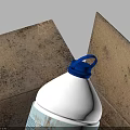 Household Items In Open Cardboard Box With White Bottle Blue Cap And Orange Can