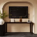 Wooden Console Table with Black Artwork White Vase and Table Lamp on Arched Beige Wall