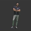 Smiling Man in Gray T Shirt and Green Pants with Arms Crossed Against Gray Background