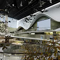 Modern Cultural Center Interior With Curved Walkway Crane Sculptures Water Features And Greenery