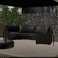 Outdoor Wicker Sofa With Gray Cushions Round Coffee Table And Green Plants By Stone Wall
