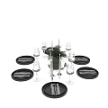 Modern Tableware Set with Black Plates Stainless Steel Cutlery Wine Glasses Candles and Green Foliage