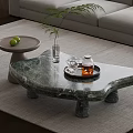 Unique Shape Marble Coffee Table with Tray Teacups Vase Green Plant and Gray Sofa