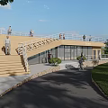 Scenic Rest Pavilion With Wooden Stairs Green Lawn And People Walking