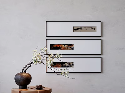 Three Framed Artworks on Gray Wall with Vase and White Flowers on Small Table 3d model