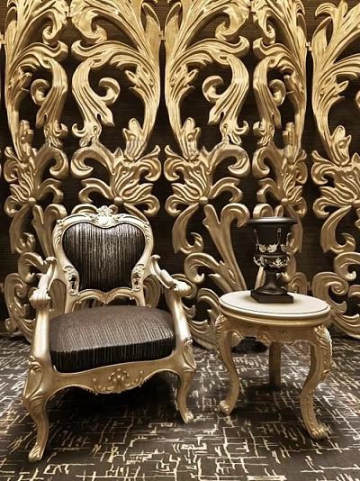 Ornate Golden Carved Single Sofa With Black Cushion And Side Table Against Carved Wall 3d model