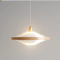Gold And White Multi Layered Circular Chandelier Hanging Against Gray Background Illuminated