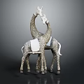 Two White and Gray Giraffe Sculptures With Intertwined Necks and Decorative Blanket