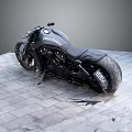 Modern Black Motorcycle Featuring Sleek Body And Black Seat On Gray Square Tiles