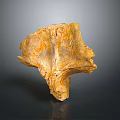 Yellow Irregular Shaped Stone With Textured Surface And Reflection On Dark Background