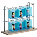 Multiple Dolls in Transparent Display Cases with Metal Frame and Wooden Base