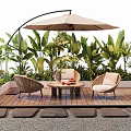 Outdoor Wicker Chairs With Patio Umbrella And Lush Green Plants On Wooden Deck