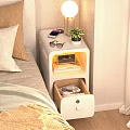 Bedside Table With Orange Lamp Alarm Clock Mobile Phone Books Cups And Drawer In Bedroom