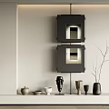 Modern Wall Decor With Black Framed Artworks And Decorative Sculptures