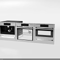 Three Stainless Steel Kitchen Appliances Wall Mounted Side by Side With Digital Controls